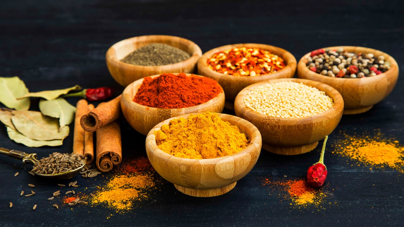 Assorted Indian spices in wooden bowls